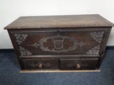 A 19th century carved oak coffer fitted with drawers