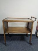A 20th century walnut and bergere two tier trolley