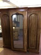 A Victorian mahogany triple door break-front wardrobe, central mirrored, panel door, fitted drawers,