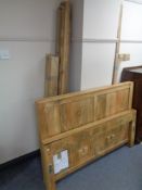 A mango wood 4' 6" bed frame