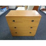A mid 20th century teak effect three drawer chest