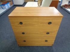 A mid 20th century teak effect three drawer chest