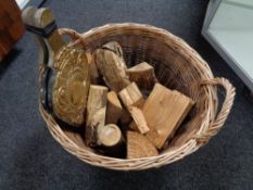 A wicker log basket containing logs and a set of brass embossed bellows