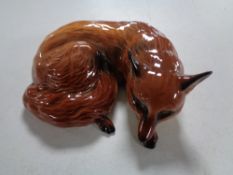 A Beswick figure, fox lying,