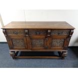 An Edwardian oak triple door sideboard on bulbous legs, height 94 cm, width 149 cm, depth 53 cm.