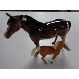 A Beswick figure of a brown horse and a figure of a foal with indistinct mark