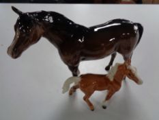 A Beswick figure of a brown horse and a figure of a foal with indistinct mark