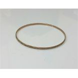 A 9ct gold bangle,