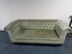 An Edwardian Chesterfield sofa in green dralon, height 210 cm, width 193 cm, depth 90 cm.