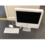 An Apple iMac model ICES-003 Class B with keyboard and mouse