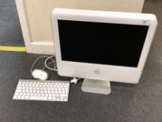 An Apple iMac model ICES-003 Class B with keyboard and mouse