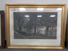 An early twentieth century monochrome print depicting a a boat by a forest