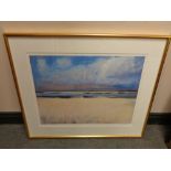 A gilt framed signed limited edition print of an estuary,