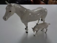 Two Beswick figures, grey dapple horse with foal.