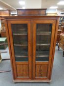 An antique mahogany glazed double door bookcase , height 158 cm, width 100 cm depth 39 cm.