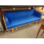 A wood framed day bed upholstered in a blue fabric, height 81 cm, width 201 cm, depth 88 cm.