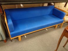 A wood framed day bed upholstered in a blue fabric, height 81 cm, width 201 cm, depth 88 cm.