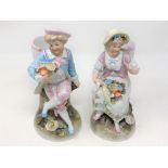 A pair of 20th century continental hand painted porcelain figures of a lady and gentleman,