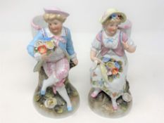 A pair of 20th century continental hand painted porcelain figures of a lady and gentleman,
