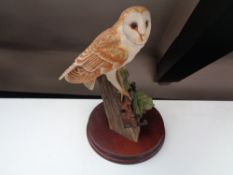 A Border Fine Arts figure of a barn owl on wooden stand