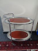 A mid 20th century chrome two tier tubular metal trolley with mirrored shelves