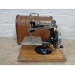 A mid 20th century child's Lead sewing machine in case