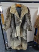 A lady's full length simulated fur coat