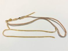 A tri-colour 9ct gold necklace (one strand broken) with non-gold magnetic clasp,