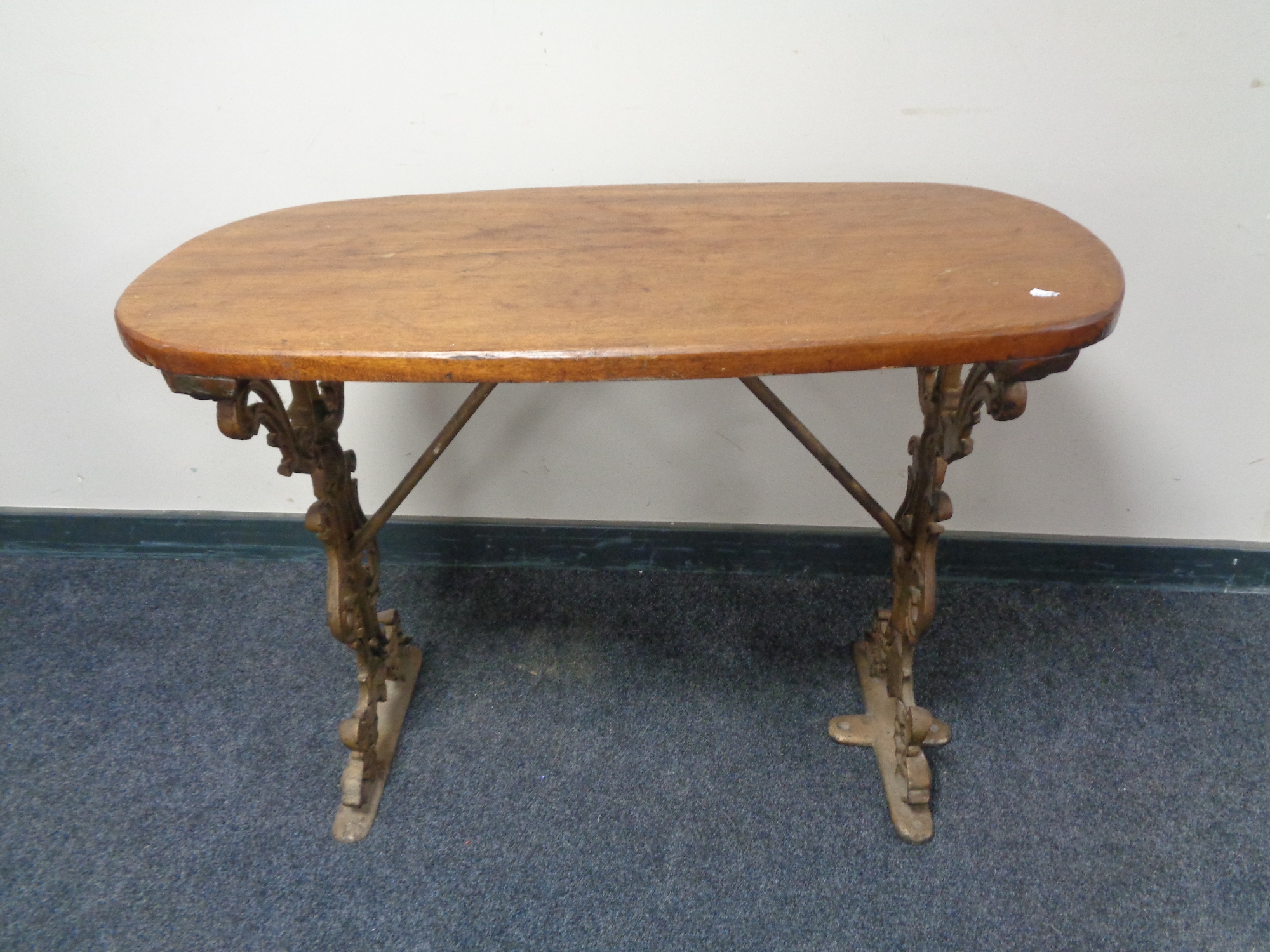 A 20th century pub table on painted cast iron legs