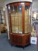 A late Victorian mahogany bowfronted display cabinet on raised legs
