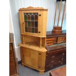 A blond oak leaded glass door corner cabinet