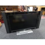 A Philips 32 inch LCD TV with lead and remote