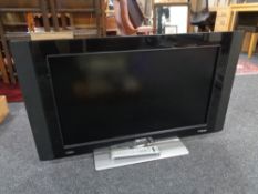 A Philips 32 inch LCD TV with lead and remote