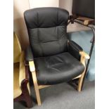 A beech framed black leather adjustable armchair