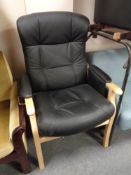 A beech framed black leather adjustable armchair