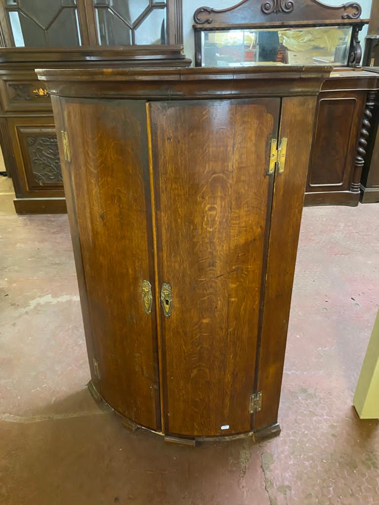 A Georgian oak double door hanging corner cabinet