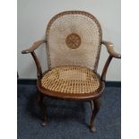An Edwardian beech framed bergere armchair