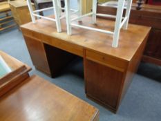 An early 20th century twin pedestal desk fitted three drawers