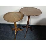 A mahogany pie crust edge pedestal wine table and a similar walnut table