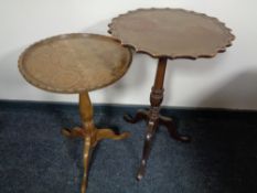 A mahogany pie crust edge pedestal wine table and a similar walnut table