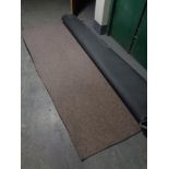 A piece of brown hard wearing office style carpet