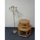 A metal floor standing candle holder and two bamboo and wicker octagonal occasional tables