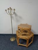 A metal floor standing candle holder and two bamboo and wicker octagonal occasional tables