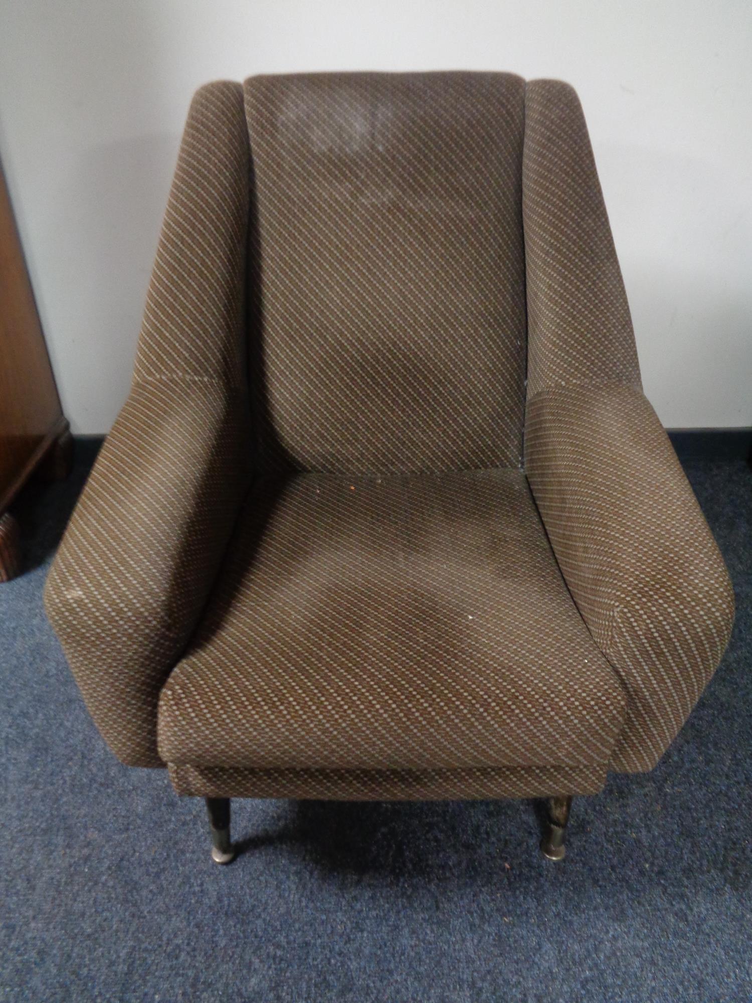 A mid 20th century armchair in brown fabric