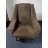 A mid 20th century armchair in brown fabric