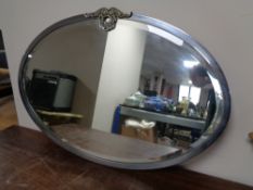 A 1930s oval chrome framed mirror