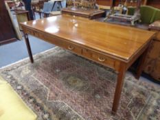 An early 20th century mahogany extending writing table fitted three drawers