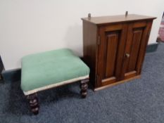 An Edwardian double door wall cabinet and footstool