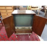 A mid 20th century Linnet and Laursen television in walnut cabinet