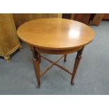 An early 20th century circular inlaid mahogany occasional table on paw feet